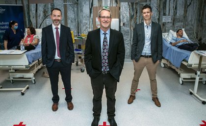 Professor Trent Munro, Professor Paul Young and Assistant Professor Keith Chappell stand in the clinic with the first participants of the Phase I clinical trial of the UQ COVID-19 vaccine.